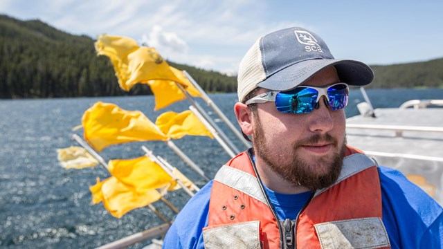 An SCA employee riding on a boat.