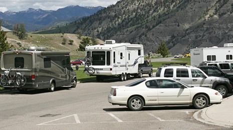 RVs and other vehicles parking along a street.