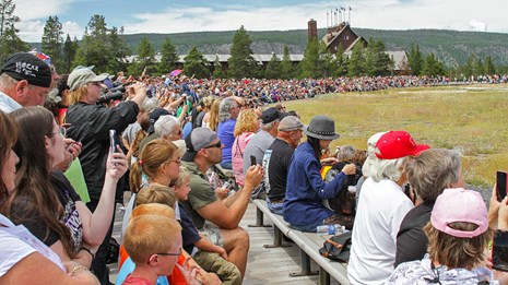 Photo of people waiting at an eruption of Old Faithful