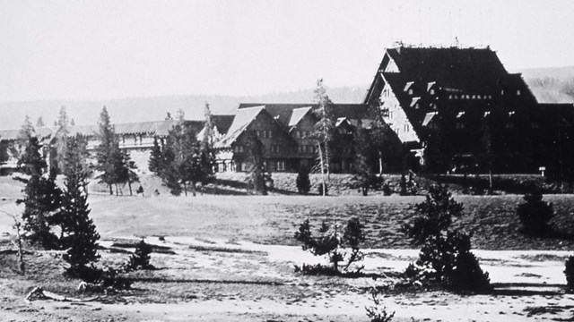 Black and white image of a large, wooden A-frame structure.