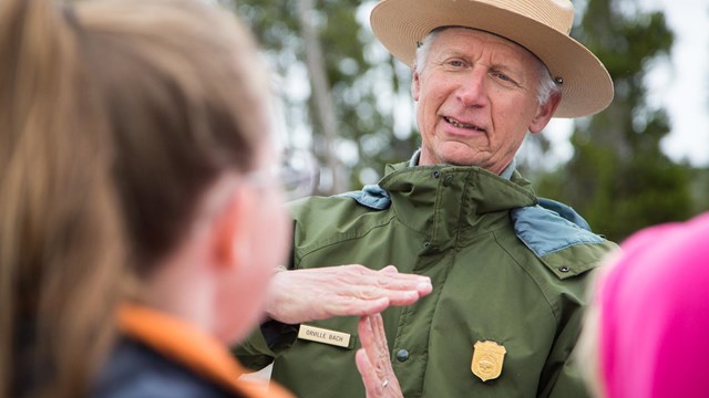 A ranger answers questions after an eruption of Old Faithful.