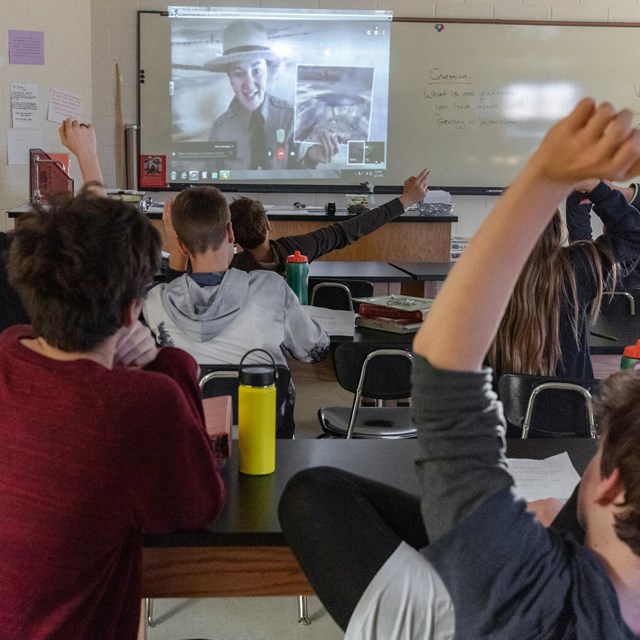 A ranger displayed on a screen in a classroom.