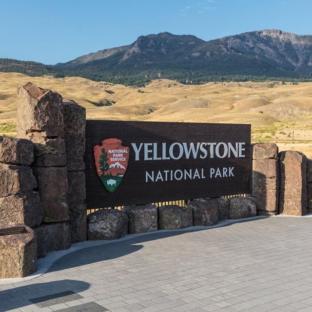 a large wooden Yellowstone National Park entrance sign