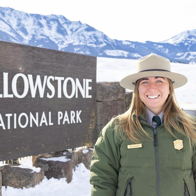 Ranger in front of sign