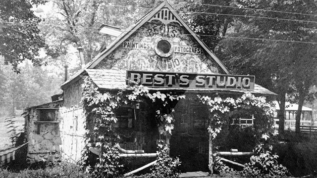 Stone cottage with a sign that says Best's Studio
