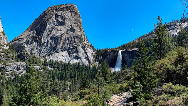 Liberty Cap and Nevada Fall in the distance, with a trail in the foreground