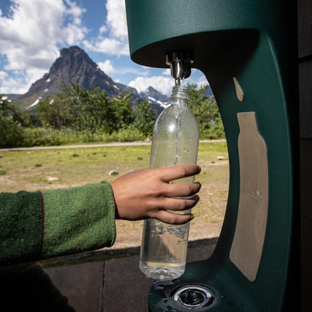 a water bottle filling station is used to refill a water bottle