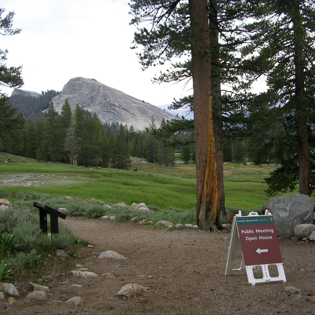 Public meeting sign near Parsons Lodge in Tuolumne Meadows with Lembert Dome in back