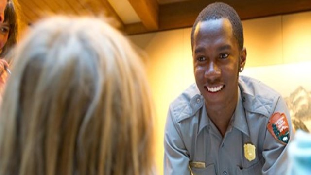 Young man wearing an NPS shirt smiles