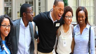 Large group of HBCUI students pose for group photo in business professional attire.