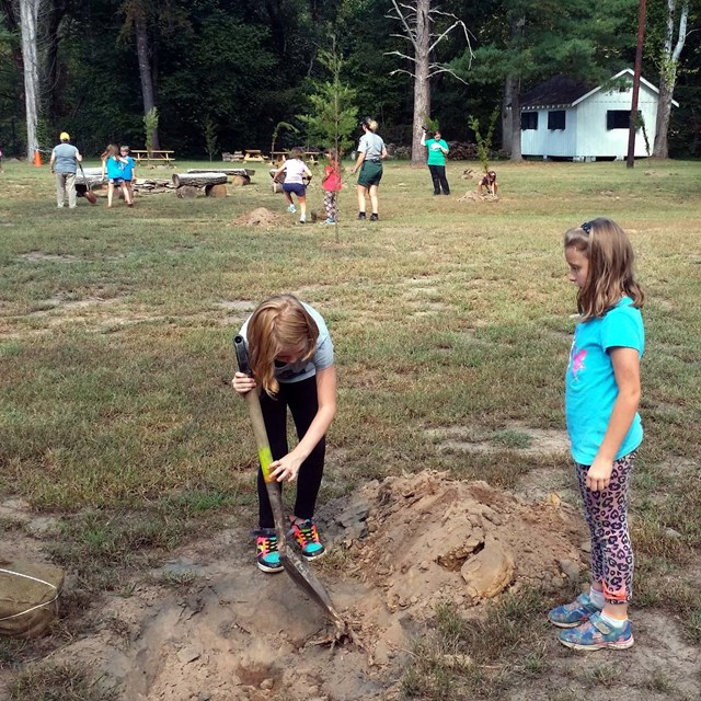 2 Girl Scouts complete a service project. 