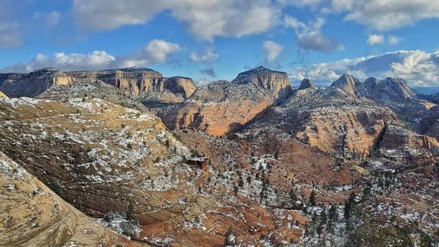 Snow on mountains with blue skies.