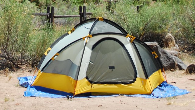 A tent in a gravel campsite.