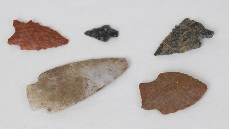 5 carved arrowheads