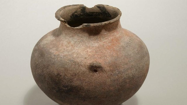 A historic pot photographed inside the park museum building.