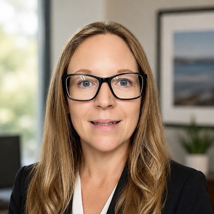 Headshot of woman with brown hair and glasses