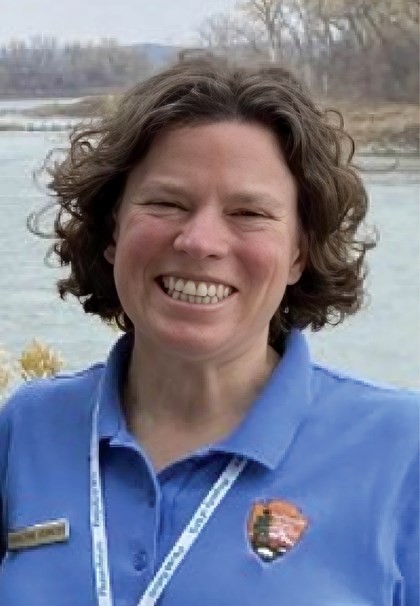 Smiling woman in blue shirt with NPS logo