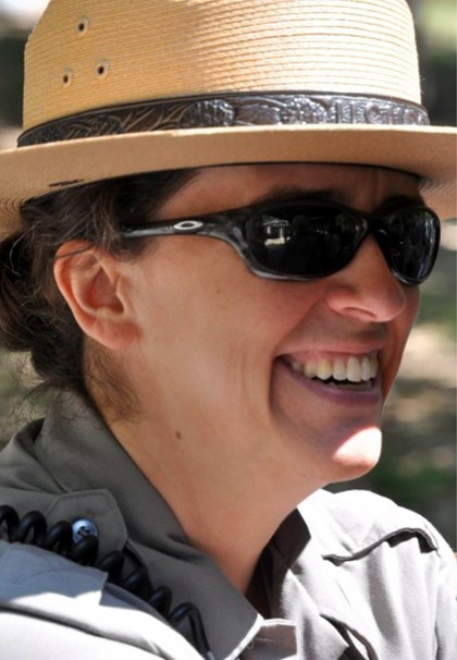 Smiling woman in NPS uniform with straw hat