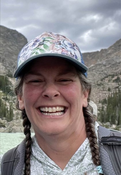 Smiling woman with hat and braids