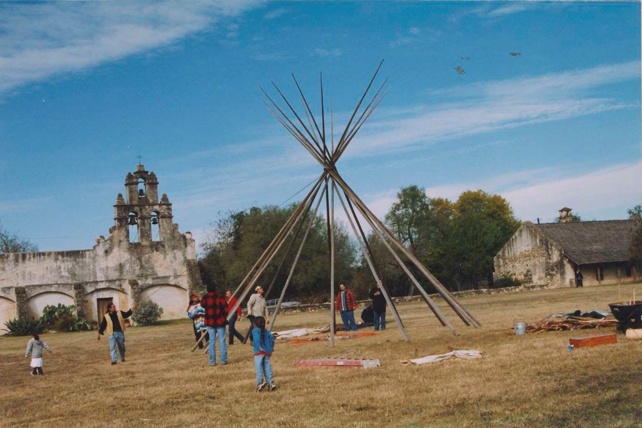Group of people setting up a structure in front of a church
