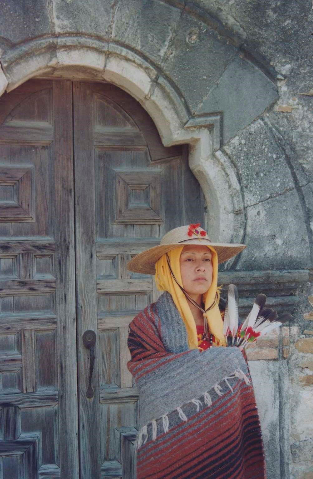 Woman in traditional clothing in front of a church door