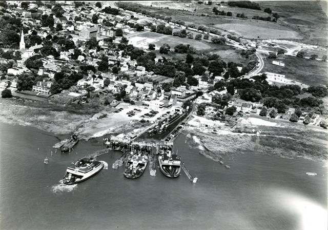 Cars lined up at the ferry terminal with ferry boats