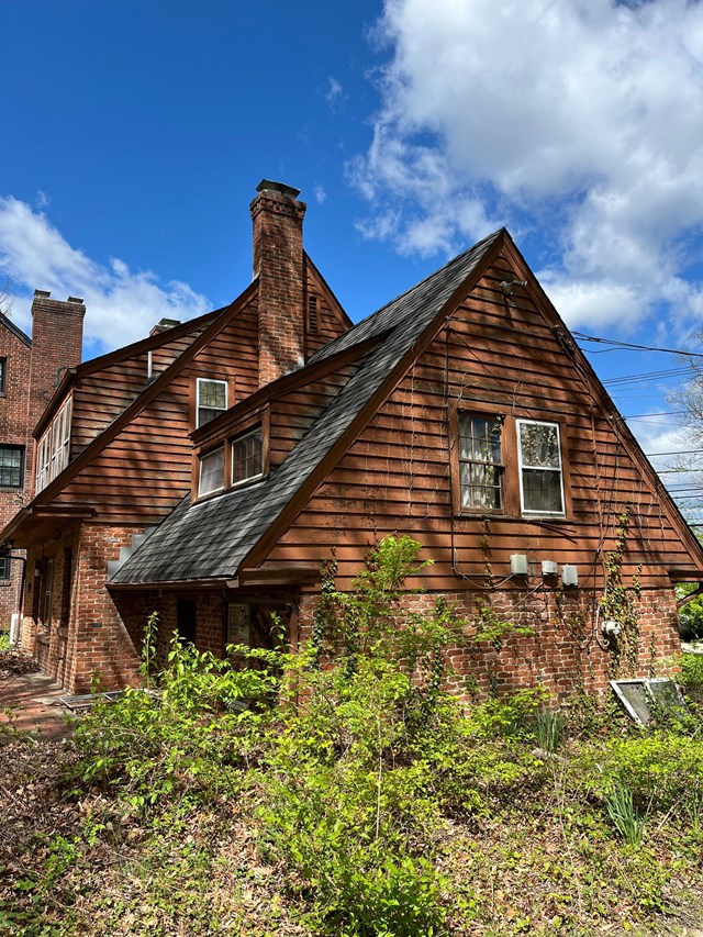 a two-story brick and wood sided house