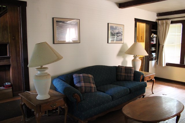 a living room with a couch, end tables, lamps, and a coffee table