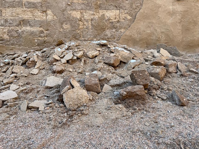 Detail of a pile of bricks and associated debris that have fallen from the south wall of the wagon alley.