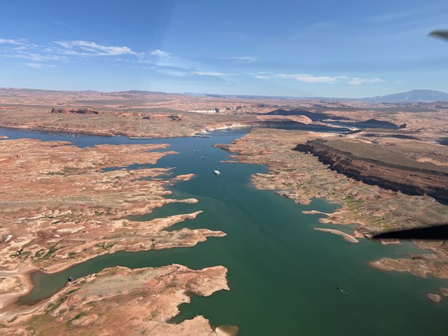 Aerial view of a desert lake with marina at far edge