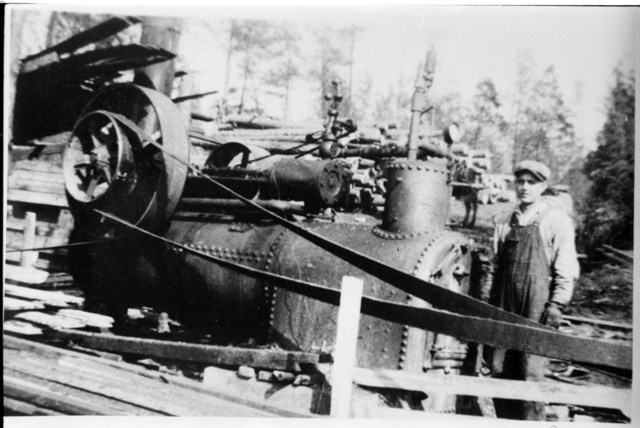 A black and white photo of a train and person.