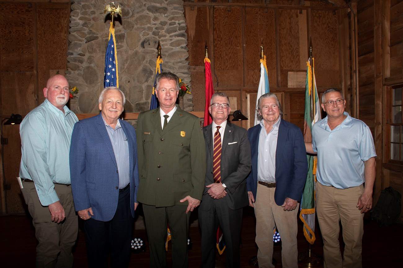 A group of people posing for a photo in suits.