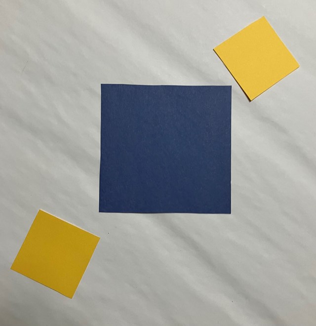 3 square in a diagonal row. One large blue square in the middle and 2 yellow squares.