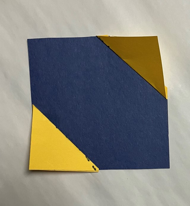 A blue square with a triangle yellow corner to bottom yellow corner.