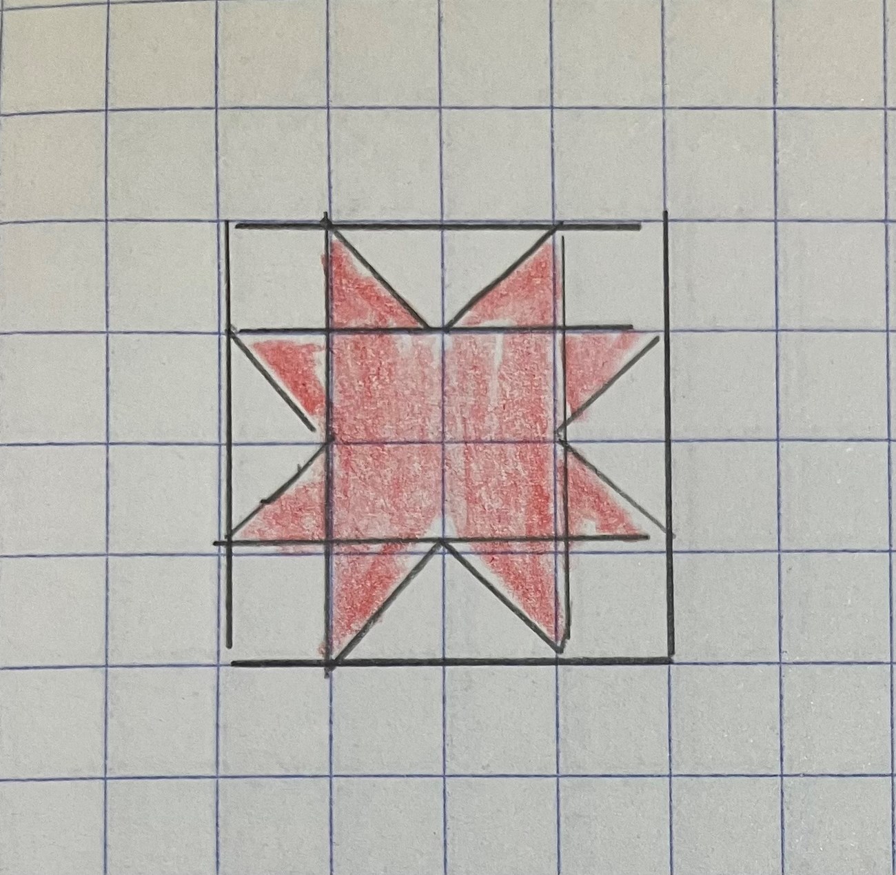 A red star drawn on gridded paper.