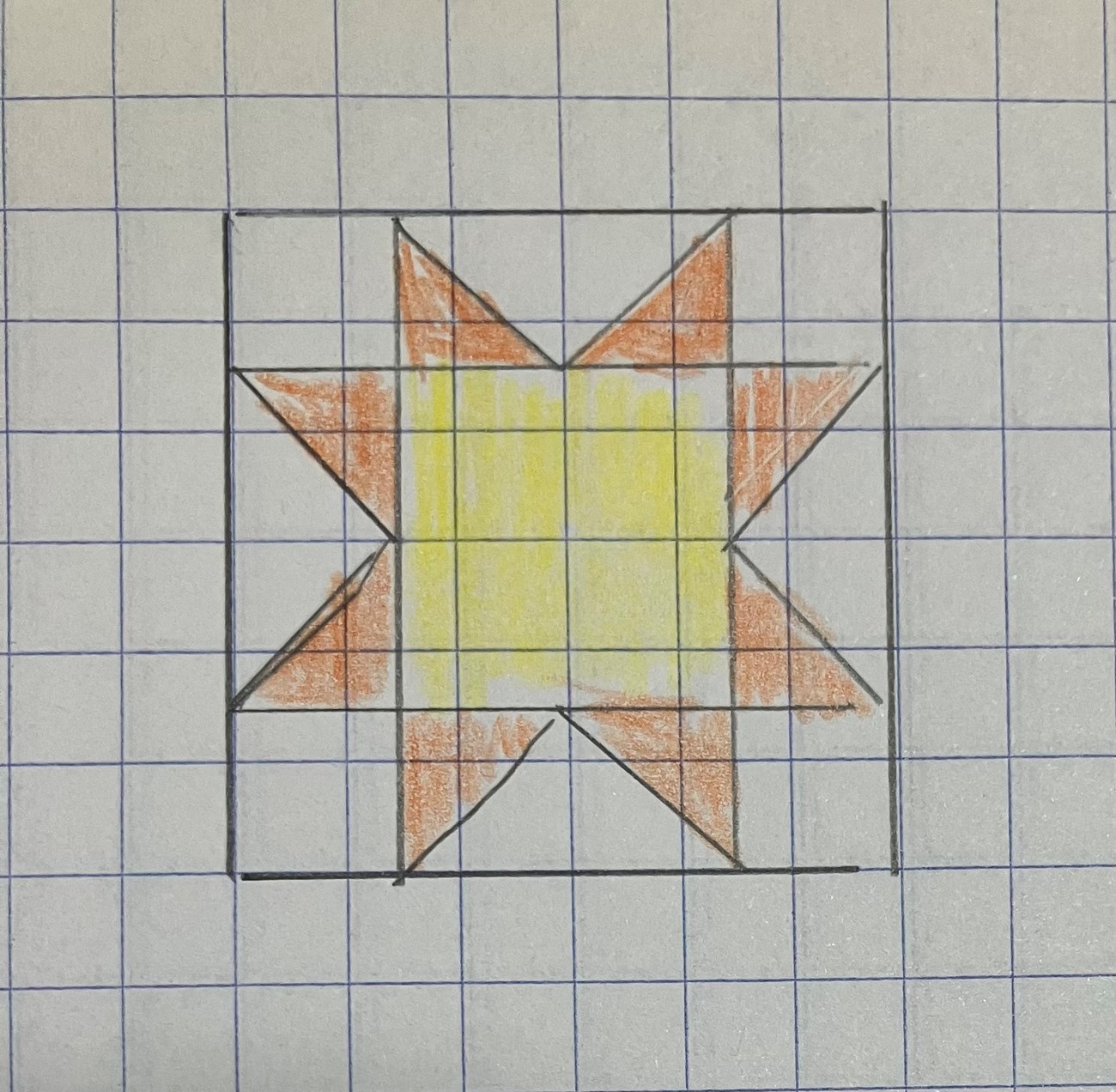 A yellow and orange star drawn on gridded paper.