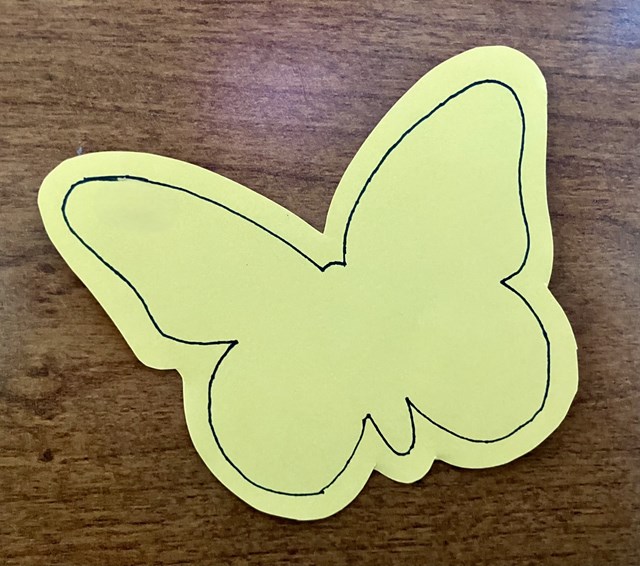 A cut out of a butterfly on a table.