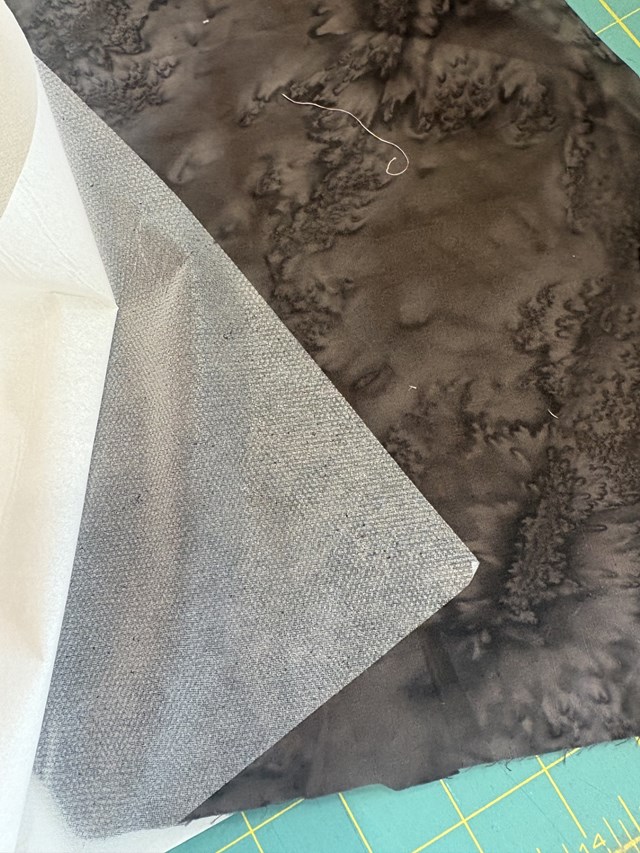 Two pieces of white fabric separated. 