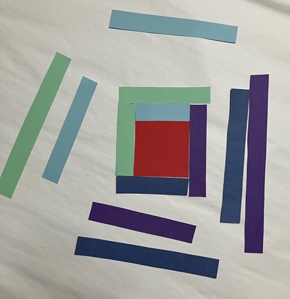 Strips of paper around a red square.