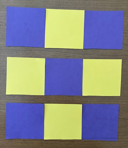 A 3x3 set of yellow and blue block cut-outs, 3 rows apart