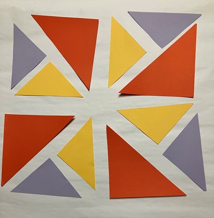 Triangles of different colors laid out in a block.