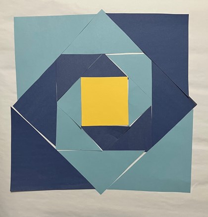 Blue and yellow paper laid out on a white background in triangle and square shapes.