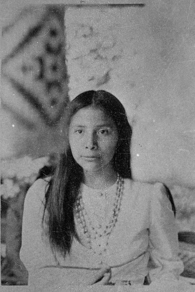 A Cherokee woman sitting in black and white