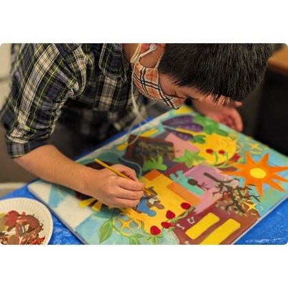 Person painting on their colorful canvas