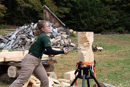 UVM Timbersports team member chops wood block with an axe