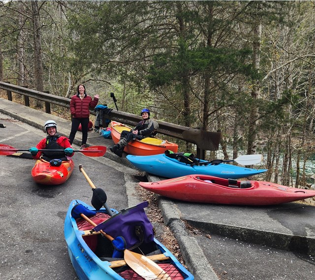 Kayaks on concrete at the parking lot.