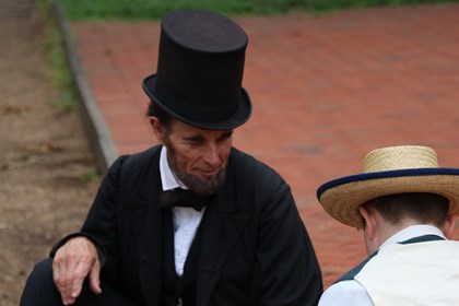 Abraham and Tad Lincoln playing games outside of the Lincoln Home