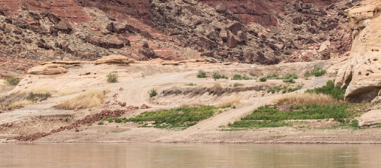 View across a river to a primitive boat ramp