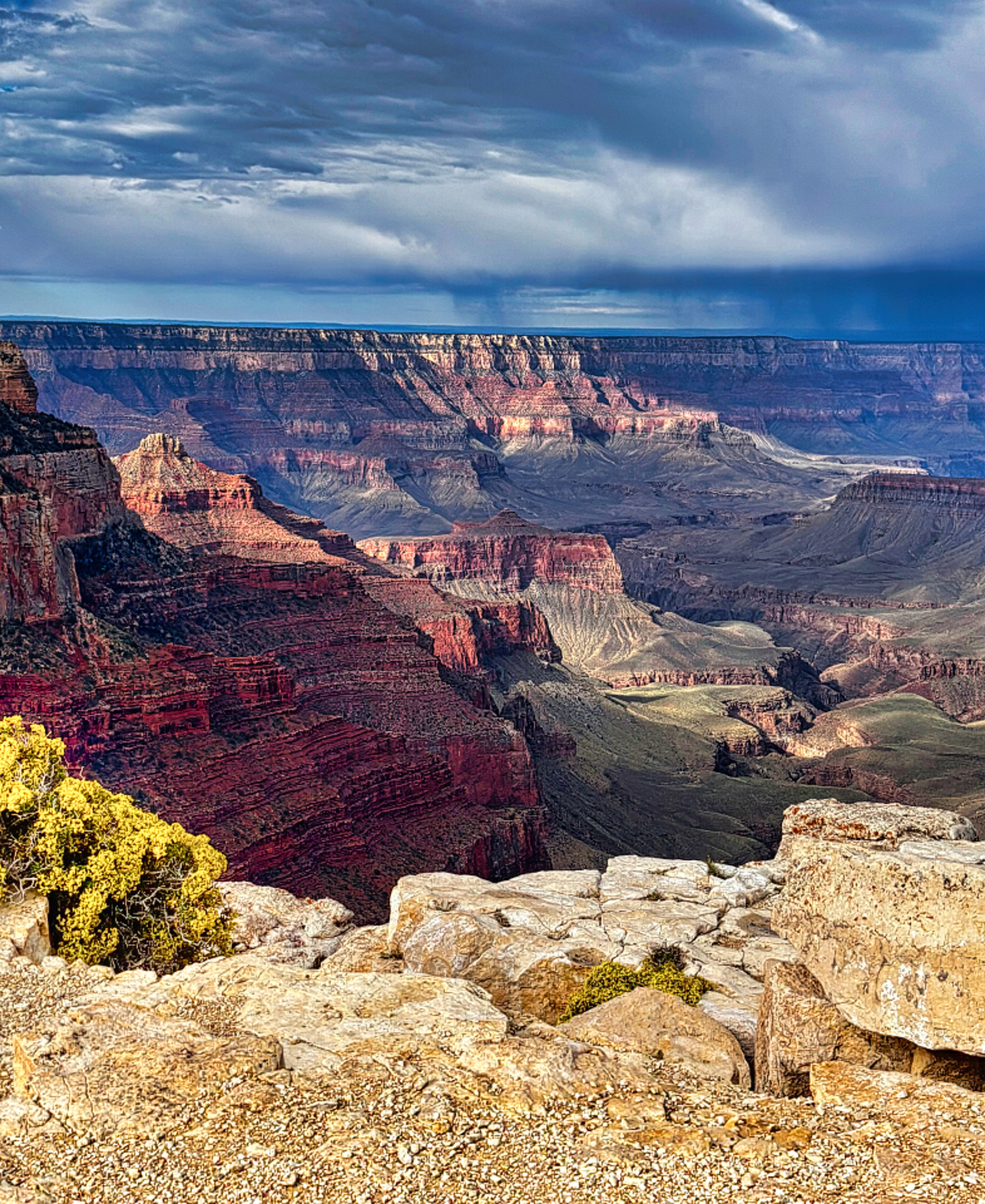 Photo of two men with topographical equipment on edge of cliff