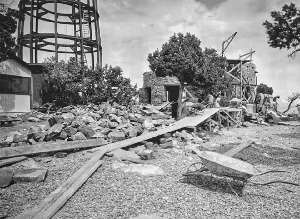 Construction site with wheelbarrow and steel frame for tower